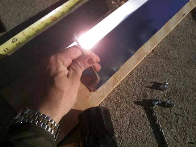 Figure 18: Punching the Screw Holes with a Nail